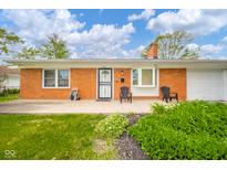 Inviting red brick home with a tidy front yard, seating on the front porch, and a well-maintained exterior at 3846 Alsace Pl, Indianapolis, IN 46226