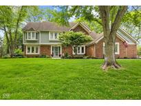 Charming two-story home with a well-manicured lawn and mature trees in a peaceful, established neighborhood at 4619 Allen Dr, Carmel, IN 46033
