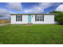 Cozy single-story home with a green lawn, quaint shutters, and a bright, inviting front door at 4632 Willowbrook Dr, Columbus, IN 47203