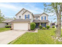 Inviting two-story home featuring blue shutters, a two-car garage, and a well-maintained front yard at 5849 Wooden Branch Dr, Indianapolis, IN 46221