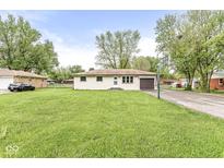 Charming single-story home with a well-maintained lawn and a basketball hoop, perfect for Gathering fun at 645 W Stop 11 Rd, Indianapolis, IN 46217