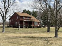 Charming two-story home with a large deck, perfect for outdoor entertaining and relaxing at 7140 N Michigan Rd, Fairland, IN 46126