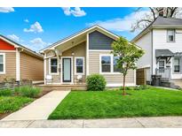 Charming bungalow with a freshly cut lawn and cozy front porch sitting area, perfect for enjoying the outdoors at 829 Olive St, Indianapolis, IN 46203