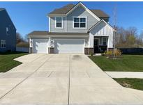 Beautiful two-story home with a three-car garage and well-maintained lawn at 9074 Larson Dr, Pendleton, IN 46064