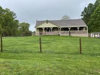 Charming ranch-style home with a welcoming front porch and well-maintained lawn at 9510 N Cooney Rd, Mooresville, IN 46158