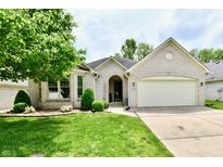 Charming single story home featuring a well-manicured front yard and attached garage at 10713 Stable Dr, Indianapolis, IN 46239