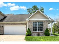 Charming brick home featuring a two-car garage, well-maintained lawn, and inviting curb appeal at 1118 Kristi Ct, Greenwood, IN 46142