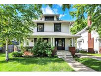 Charming two-story home with a covered porch and a well-manicured front yard at 1124 E 35Th St, Indianapolis, IN 46205