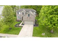 Charming two-story brick home with manicured lawn, inviting driveway, and welcoming landscaping at 11243 Catalina Dr, Fishers, IN 46038
