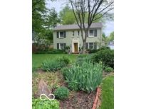 Charming home with a well-manicured front yard and mature trees creating a serene and inviting curb appeal at 1138 E 58Th St, Indianapolis, IN 46220