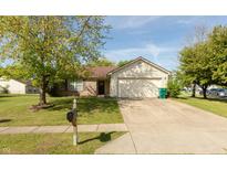 Charming single-story home featuring a well-manicured lawn, brick accents, and attached two-car garage at 1157 Fielding Ln, Franklin, IN 46131