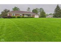 Charming brick home with well-manicured lawn and mature trees at 1209 S Rangeline Rd, Anderson, IN 46012