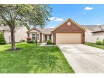Charming single-story home with a well-manicured lawn, inviting curb appeal, and a two-car garage at 12256 Sagamore Woods Dr, Fishers, IN 46037