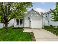 Charming home featuring a well-manicured lawn and an attached one car garage at 1242 Freemont Ln, Greenwood, IN 46143