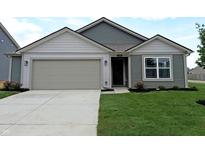 Charming one-story home featuring a well-manicured lawn and attached two-car garage at 1400 Bluebonnet Pl, Shelbyville, IN 46176