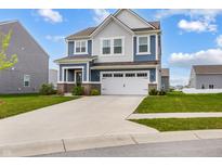 Charming two-story home features a two-car garage, blue and gray siding, and a well-manicured lawn at 1464 Buckland Ct, Avon, IN 46123