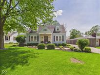 Charming light blue home with stone accents and a well-manicured front yard at 2011 Sheffield Ave, Anderson, IN 46011