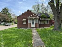 Charming home featuring a well-maintained lawn and a quaint covered entryway at 2501 Mars Hill St, Indianapolis, IN 46241