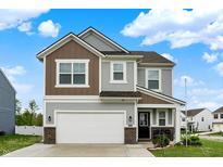 Charming two-story home featuring a two-car garage, landscaped yard and a welcoming front porch at 3719 Lexham Ct, Danville, IN 46122