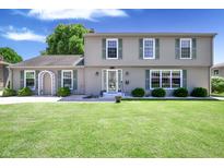 Charming two-story home with green shutters, well-manicured lawn, and inviting front entrance at 3829 Waycross Dr, Columbus, IN 47203