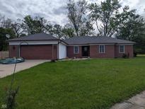 Charming brick ranch-style home featuring a well-manicured lawn and attached garage, great curb appeal at 5043 Harway Ct, Indianapolis, IN 46227
