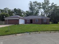 Charming brick ranch with a well-maintained lawn and a two-car garage in a mature neighborhood at 5043 Harway Ct, Indianapolis, IN 46227