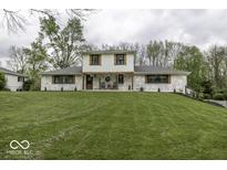 Charming two-story home featuring a manicured lawn, painted brick, and inviting front porch at 5137 Green Hills Dr, Brownsburg, IN 46112