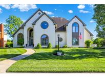 Beautiful two-story home with manicured lawn, unique architectural details, and a welcoming facade at 5521 Salem N Dr, Carmel, IN 46033