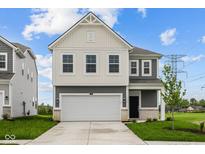Charming two-story home with a two-car garage, black door, and nicely manicured lawn at 6219 Medina Spirit Dr, Indianapolis, IN 46237