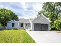Charming home with a well-manicured lawn and attached two car garage at 8066 Cardinal Cove E Dr, Indianapolis, IN 46256