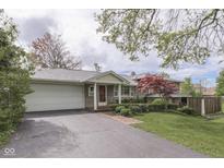 Charming front exterior with brick walkway, a well-kept lawn, and a convenient attached two-car garage at 8903 Maple Hill Dr, Indianapolis, IN 46239