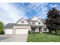 Charming two-story home featuring a well-manicured lawn, a two-car garage, and classic architectural details at 8970 Buttercup Ct, Noblesville, IN 46060