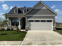 Charming single-story home featuring stone accents and a two-car garage at 13324 Roundtop Rd, Noblesville, IN 46060