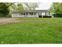 Charming single story home with a front porch and spacious lawn at 1425 E Us Highway 40, Clayton, IN 46118