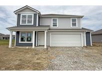 Charming two-story home with a two-car garage and inviting front porch at 1428 Aster Dr, Shelbyville, IN 46176