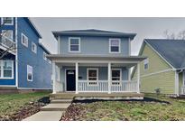 Charming two-story home featuring a cozy front porch, offering a welcoming curb appeal in a residential neighborhood at 1918 Cornell Ave, Indianapolis, IN 46202