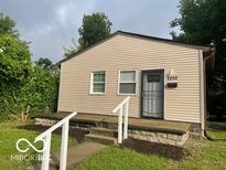 Charming single story home with tan siding and well-maintained front yard at 2202 E Brookside Ave, Indianapolis, IN 46218