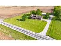 Sprawling property featuring a charming home, large lawn, and outbuilding nestled amidst picturesque farmland at 2221 W County Road 500 N, Danville, IN 46122