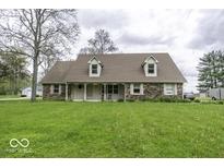 Charming brick home with a spacious front yard and covered porch, perfect for enjoying the outdoors at 3134 W Hickory Woods Dr, Greenfield, IN 46140