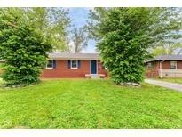 Charming brick home with well-maintained lawn and mature trees at 4013 Priscilla Ave, Indianapolis, IN 46226
