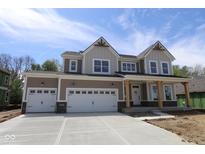 New two-story home boasting a three-car garage and inviting covered porch with natural wood supports at 4075 Persian St, Greenwood, IN 46143