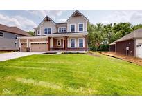 Inviting two-story home with a well-manicured lawn and a convenient three-car garage at 4075 Persian St, Greenwood, IN 46143