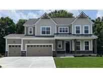 Charming two-story home with a three-car garage, covered porch, and manicured lawn in a picturesque setting at 4075 Persian St, Greenwood, IN 46143