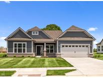 Charming one-story home with gray siding, manicured lawn, and a two-car garage at 4076 Berry Chase Blvd, Greenwood, IN 46143