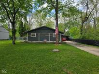 Charming single-story home with a spacious front yard, American flag, and an inviting atmosphere at 4644 N Ritter Ave, Indianapolis, IN 46226