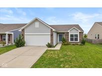Charming single-story home with a well-manicured lawn, attached garage, and classic brick and siding details at 4752 Chip Shot Ln, Indianapolis, IN 46235