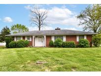 Charming single story brick home with well-manicured landscaping and white shutters on the front windows at 5101 Dickson Rd, Indianapolis, IN 46226