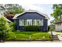 Charming single Gathering home with a well-manicured lawn and attractive dark blue painted facade at 5241 Guilford Ave, Indianapolis, IN 46220