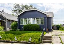 Charming single-story home featuring a well-manicured lawn, inviting entryway, and appealing exterior paint at 5241 Guilford Ave, Indianapolis, IN 46220
