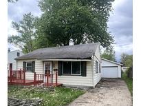 Charming single-Gathering home with quaint front porch and detached garage on a tree-lined street at 728 Lonsvale Dr, Anderson, IN 46013